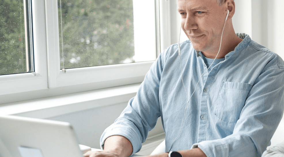 man sitting by computer